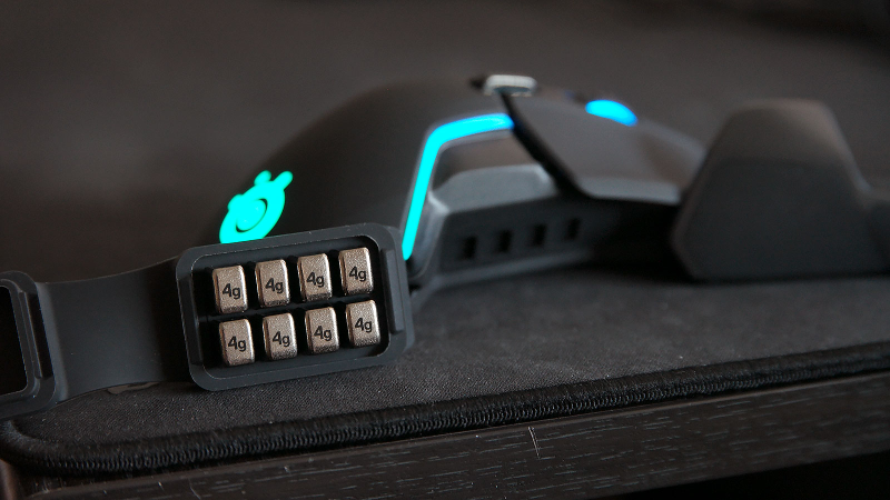 The place to put the extra weight are hidden behind the magnetic panels built into both sides of the mouse.